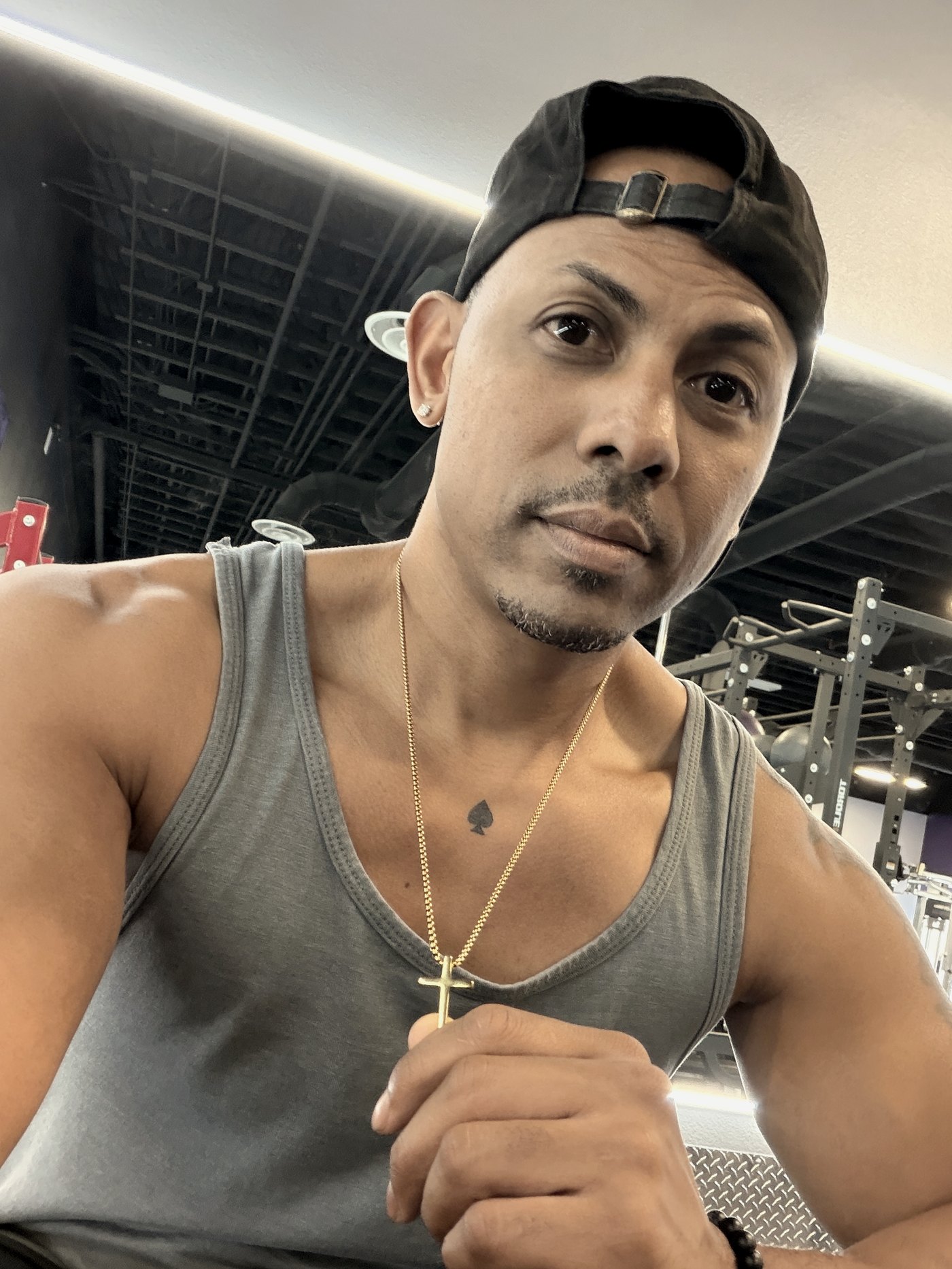 Chris Workman training in the gym, wearing a gold cross
